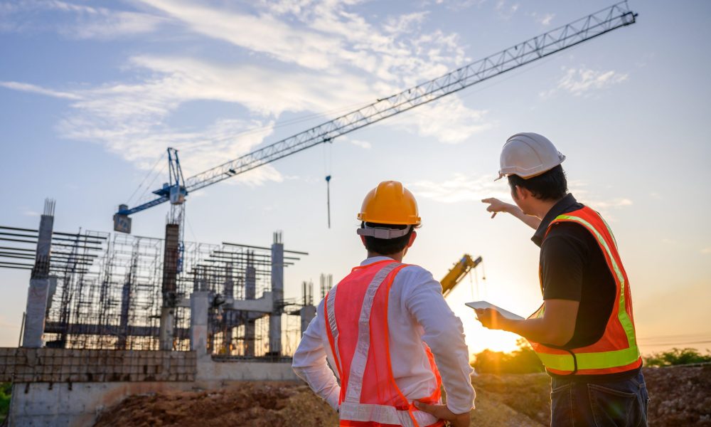 A team of construction engineers talks to managers